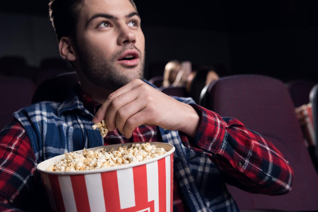 stock-photo-young-handsome-man-eating-popcorn.jpg